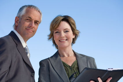 business man and woman against blue sky